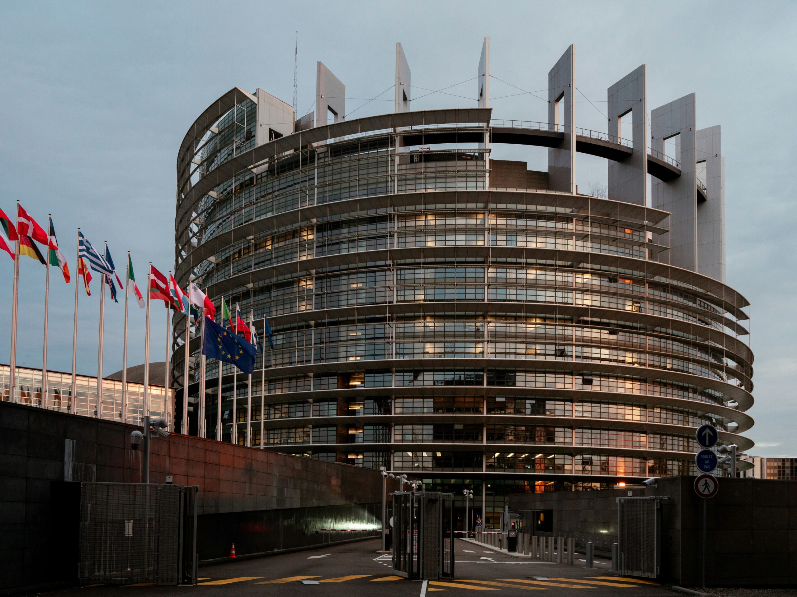 European Parliament building in Strasbourg with EU member state flags displayed in front, representing European digital policy and sovereignty